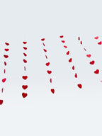 Paper Party Studio red heart garland strings for romantic wedding, anniversary, or Valentine's Day party backdrop.