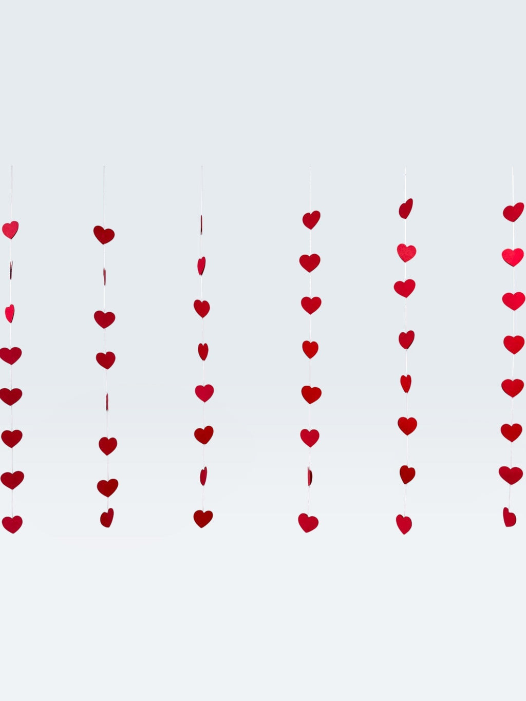 Paper Party Studio red heart garland, set of 10 strings with mini heart cut-outs, perfect for Valentine's Day or weddings.
