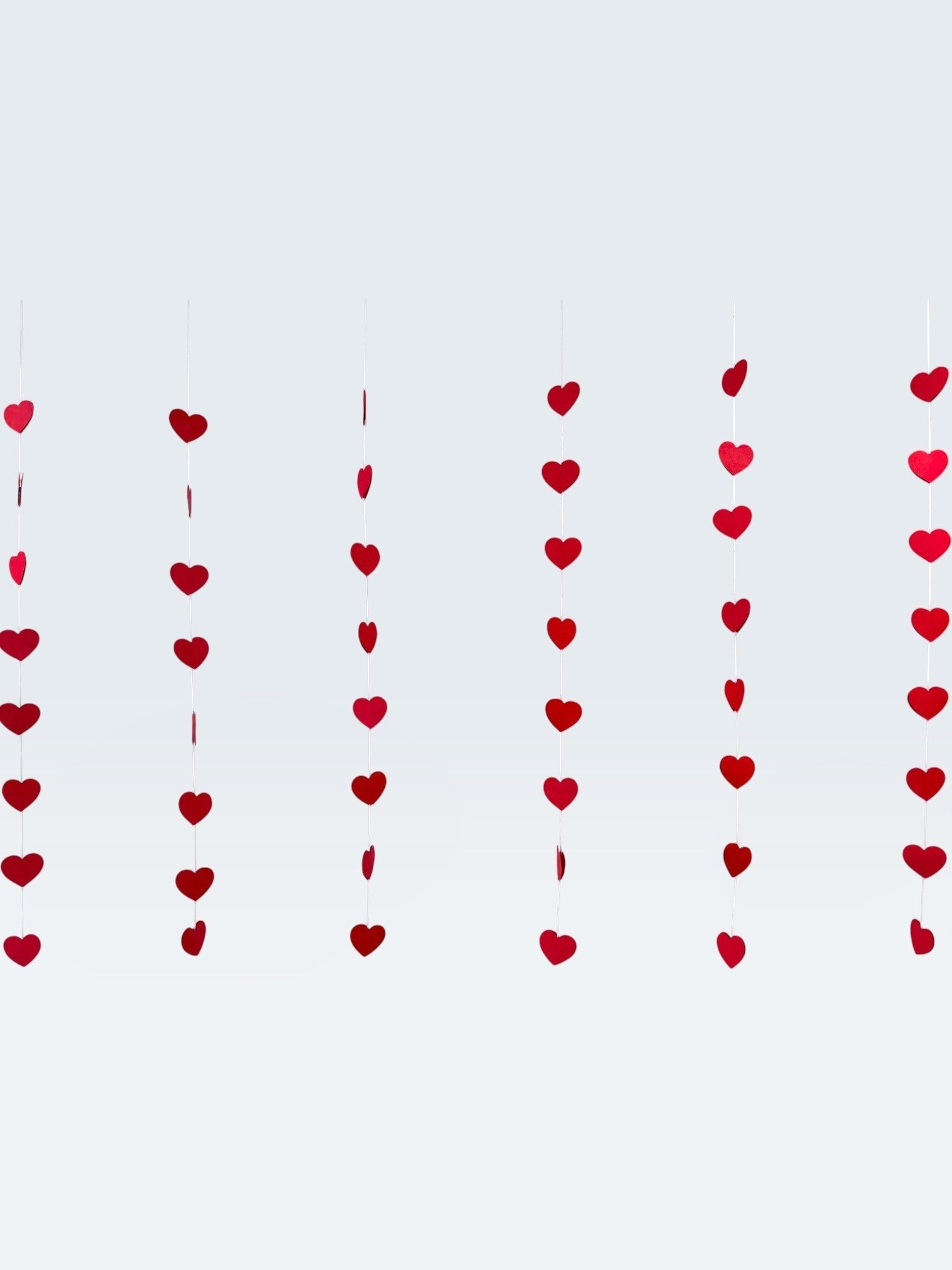 Paper Party Studio red heart garland, set of 10 strings with mini heart cut-outs, perfect for Valentine's Day or weddings.