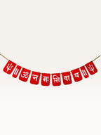 Paper Party Studio red paper banner with white Om Namah Shivaya mantra and trishul motifs for festive pooja decor