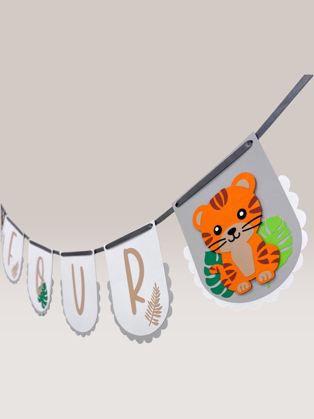 Paper Party Studio Safari Birthday Banner with white flags, kraft lettering, and a cute tiger graphic. Perfect for jungle parties.