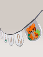 Paper Party Studio Safari Birthday Banner with white flags, kraft lettering, and a cute tiger graphic. Perfect for jungle parties.