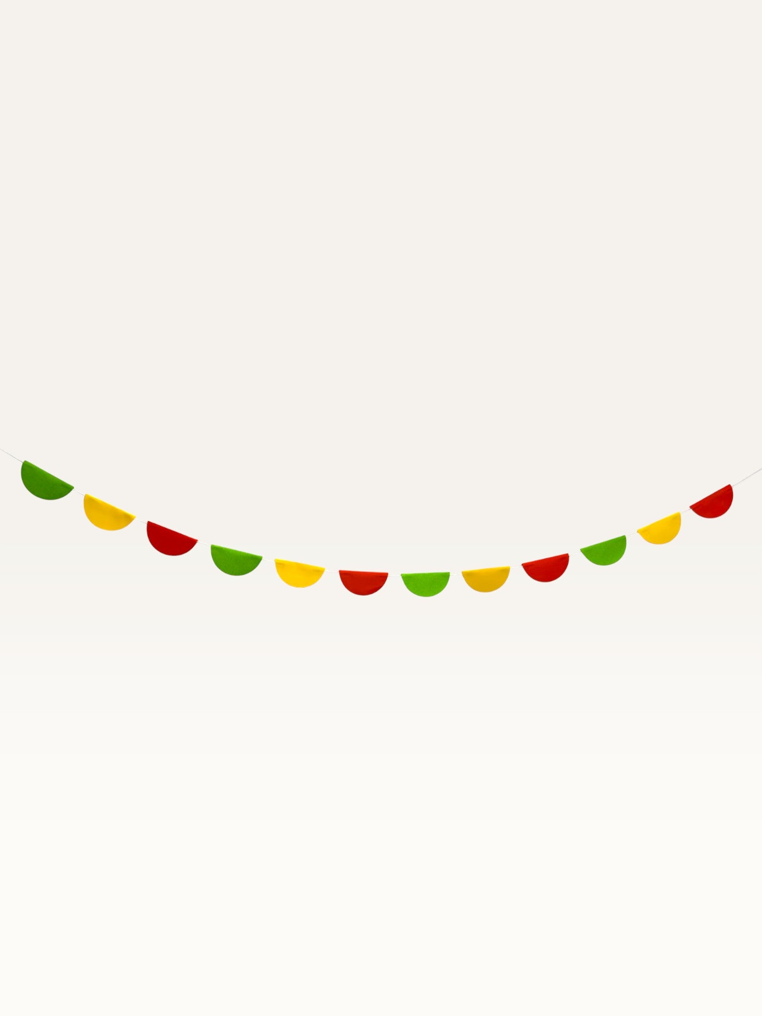 Paper Party Studio scallop garland featuring alternating red, yellow, and green paper half-circles on a string.