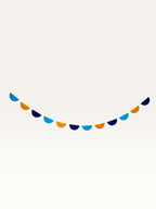 Paper Party Studio blue and yellow half-circle scallop string garland for birthday party decorations