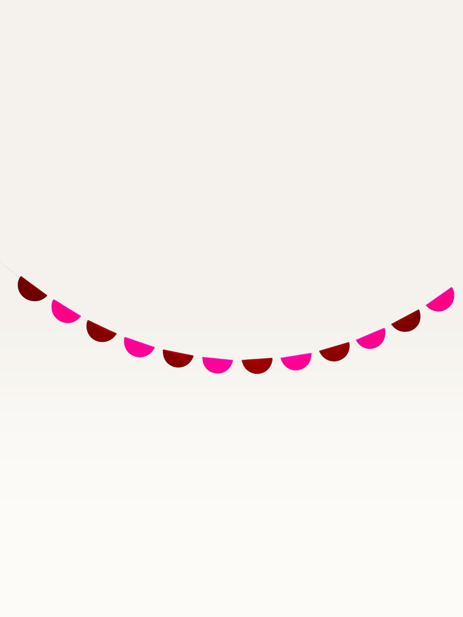 Paper Party Studio scallop garland in pink and red paper for romantic Valentine's Day or anniversary decorations.
