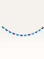 Paper Party Studio blue and purple half-circle scallop string garland for tropical luau birthday party decorations