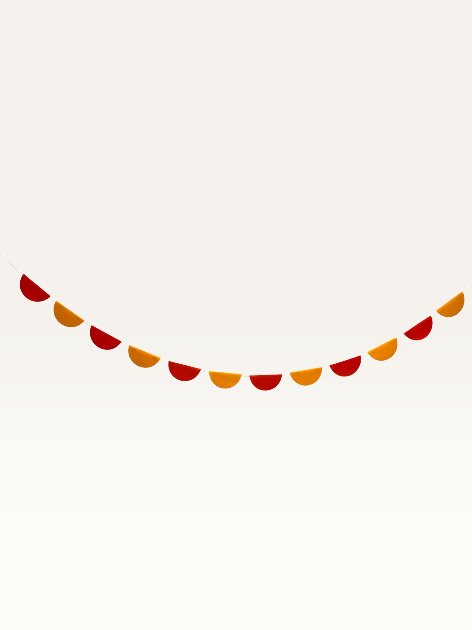 Paper Party Studio saffron and orange paper scallop garland for Shiv pooja mandir decoration