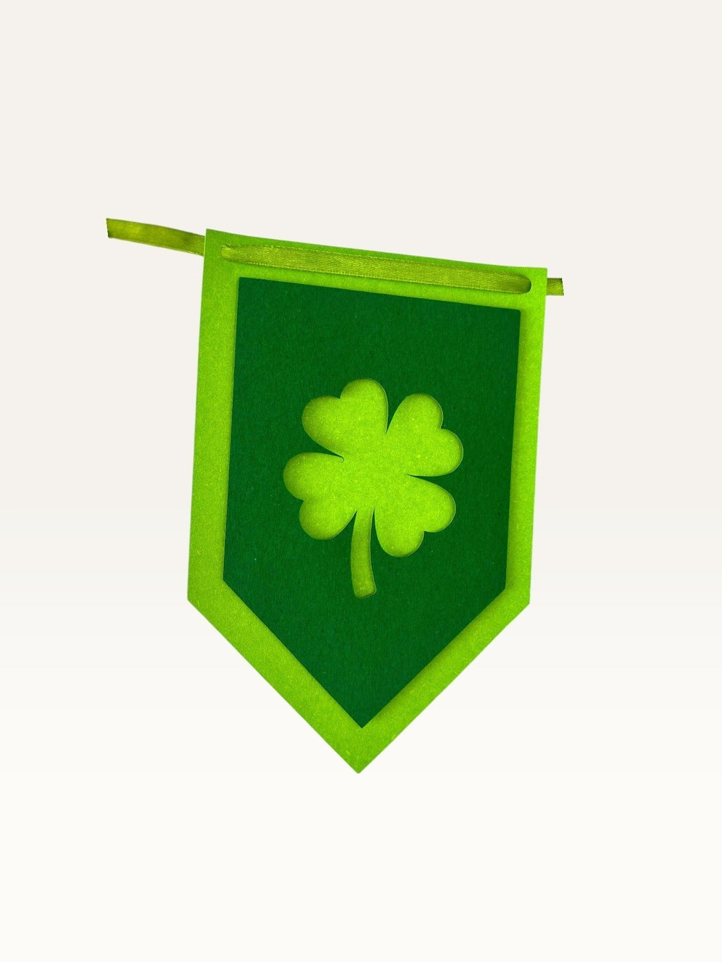 Paper Party Studio green cardstock shamrock bunting flag with a layered four-leaf clover cut-out design.