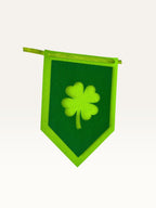 Paper Party Studio green cardstock shamrock bunting flag with a layered four-leaf clover cut-out design.