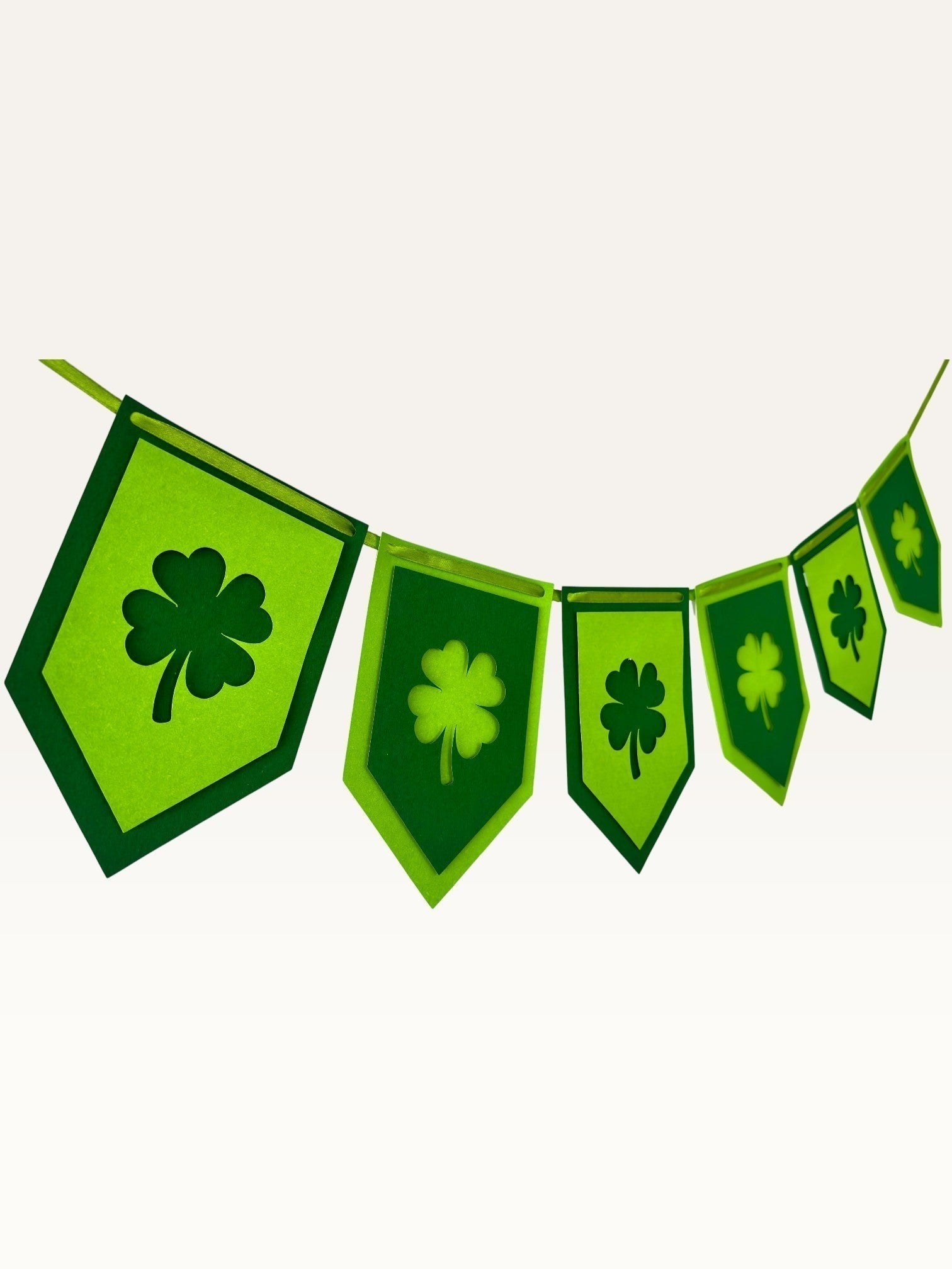 Paper Party Studio lucky shamrock bunting with layered green cardstock clover flags for St. Patrick's Day decor.