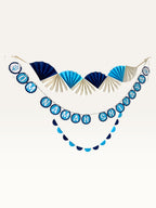 Paper Party Studio Om Namah Shivaya paper decoration set with navy, blue, and cream fan and scalloped garlands.