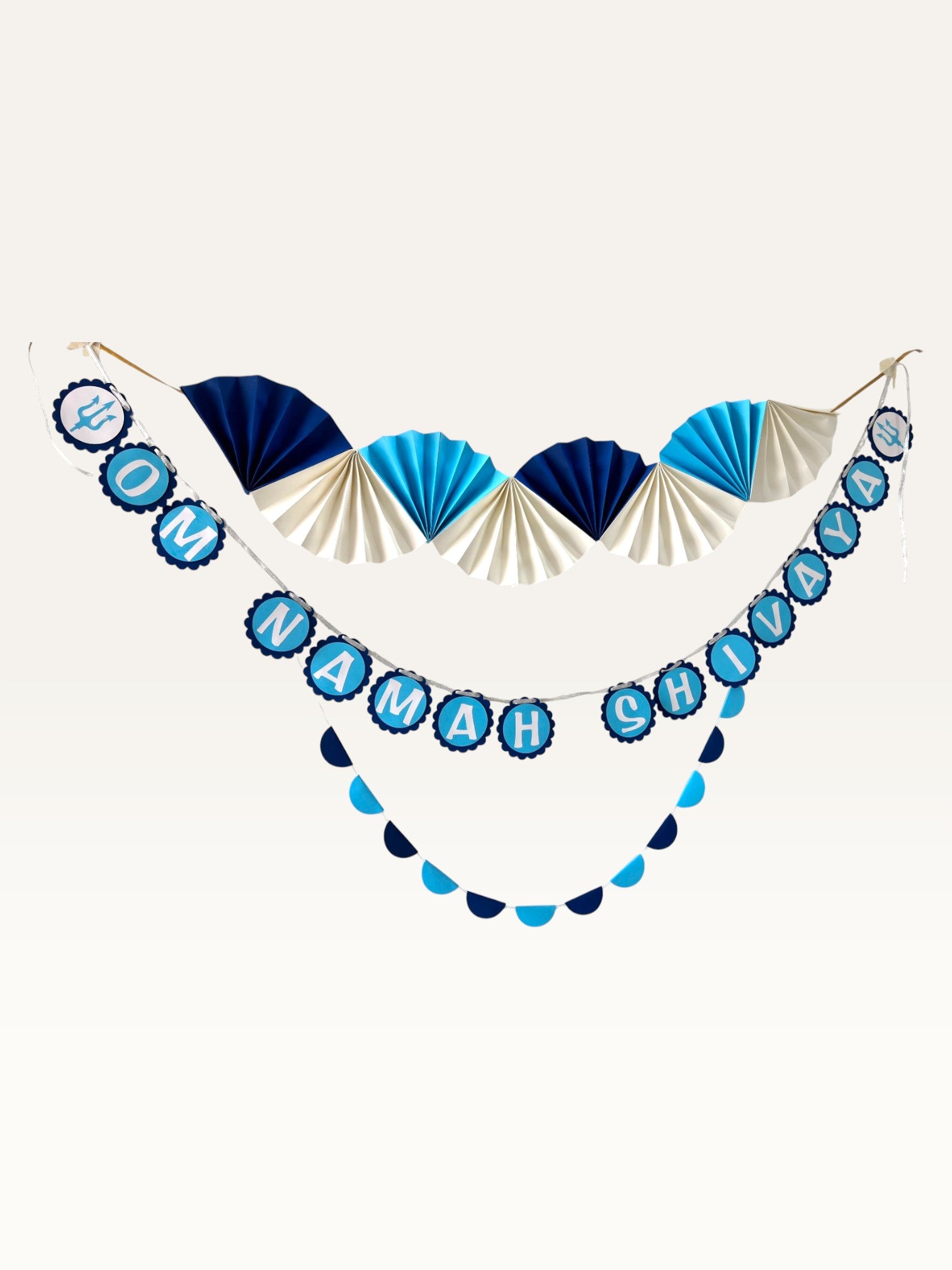Paper Party Studio Om Namah Shivaya paper decoration set with navy, blue, and cream fan and scalloped garlands.
