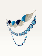 Paper Party Studio Om Namah Shivaya paper decoration set featuring navy, blue, and cream fan and scallop garlands.