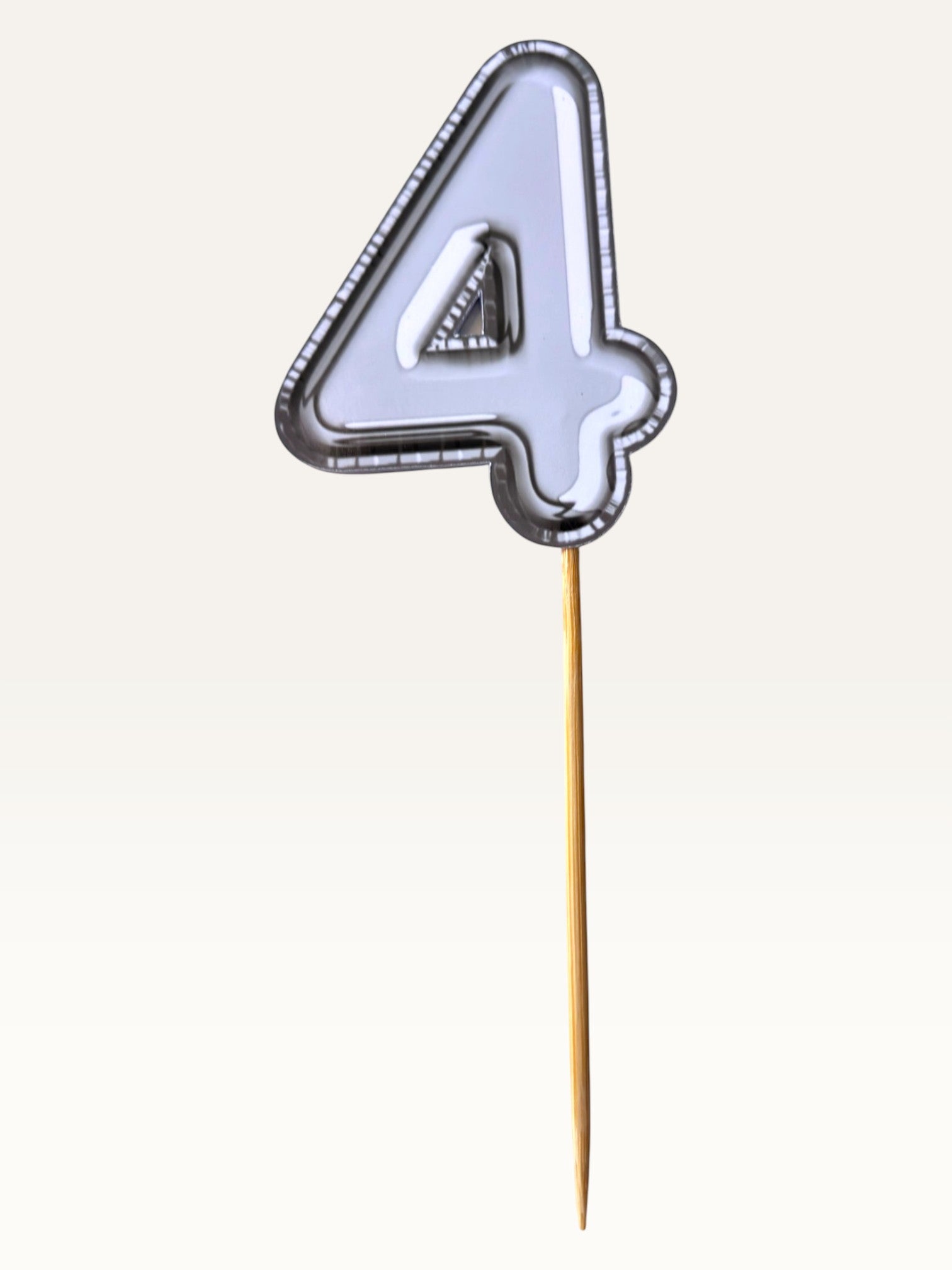 Paper Party Studio silver foil number 4 cake topper with a sleek chrome finish on a bamboo stick.
