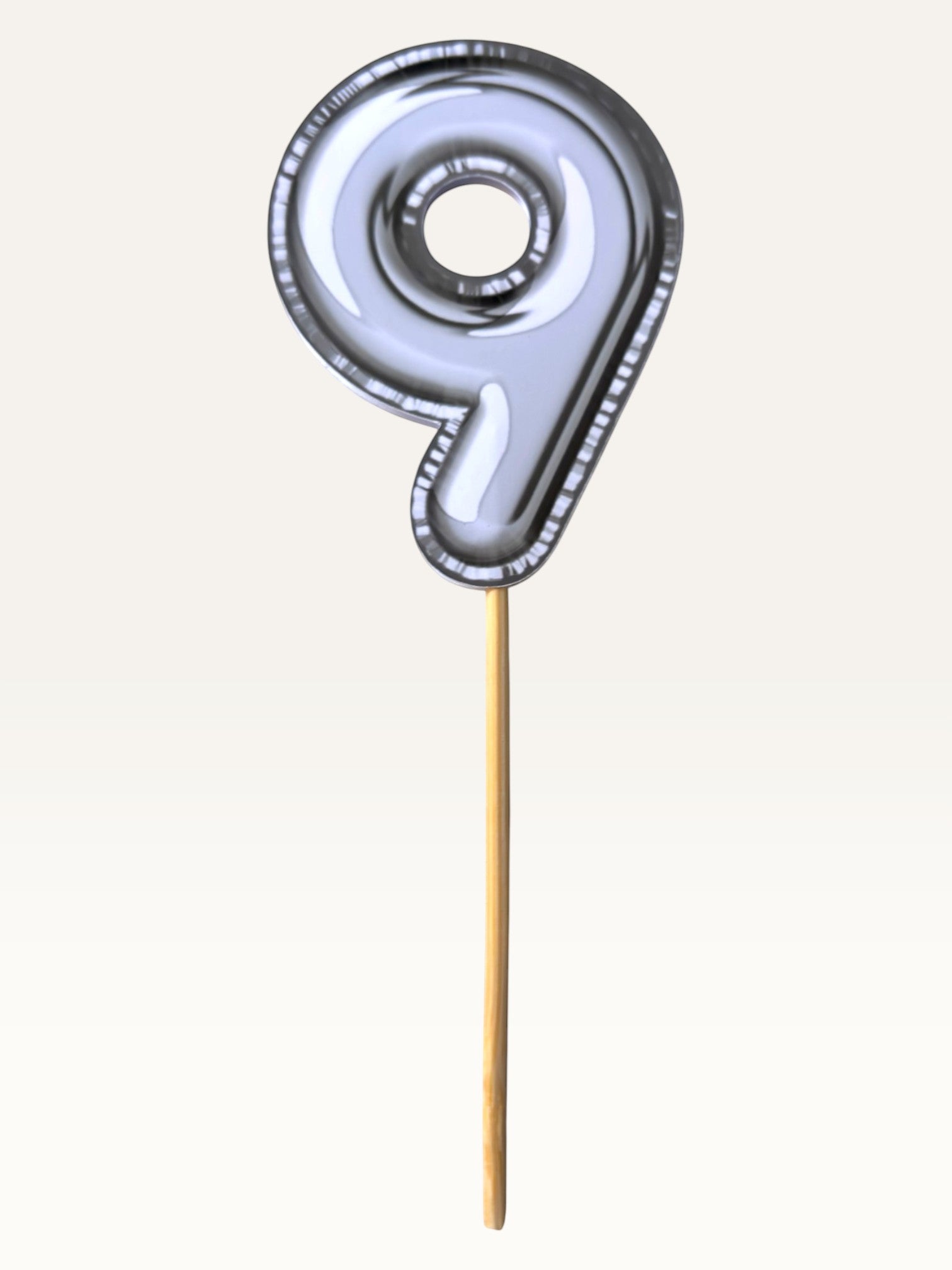 Paper Party Studio silver foil number 9 cake topper with a sleek chrome finish and bamboo stick for birthday cakes.