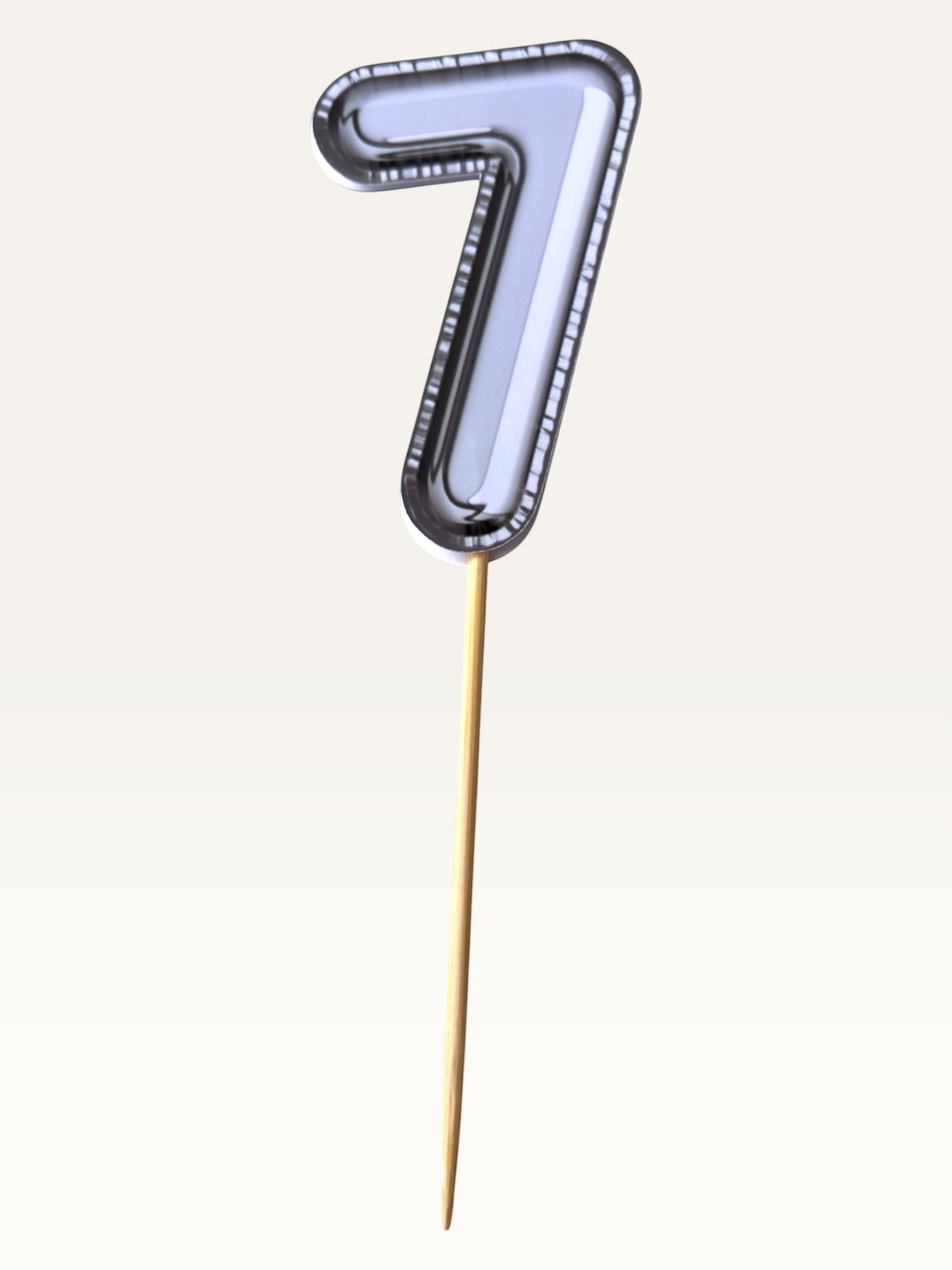 Paper Party Studio silver foil number seven cupcake topper on a bamboo stick for birthday party decorations.