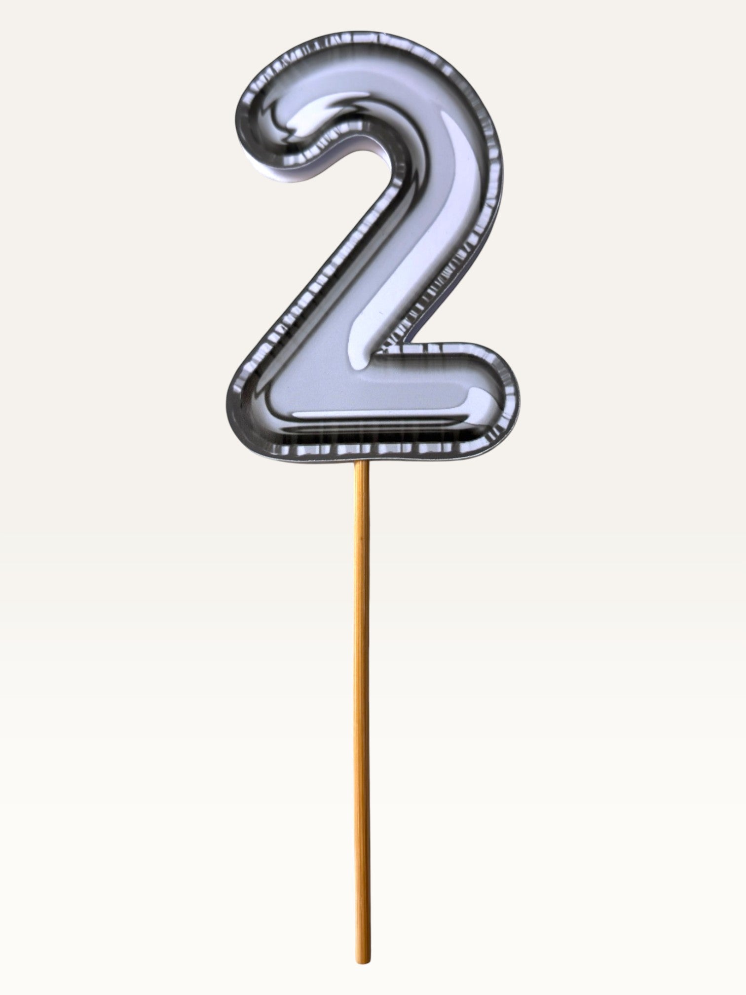 Paper Party Studio silver foil number 2 cake topper with a sleek chrome finish on a bamboo stick.