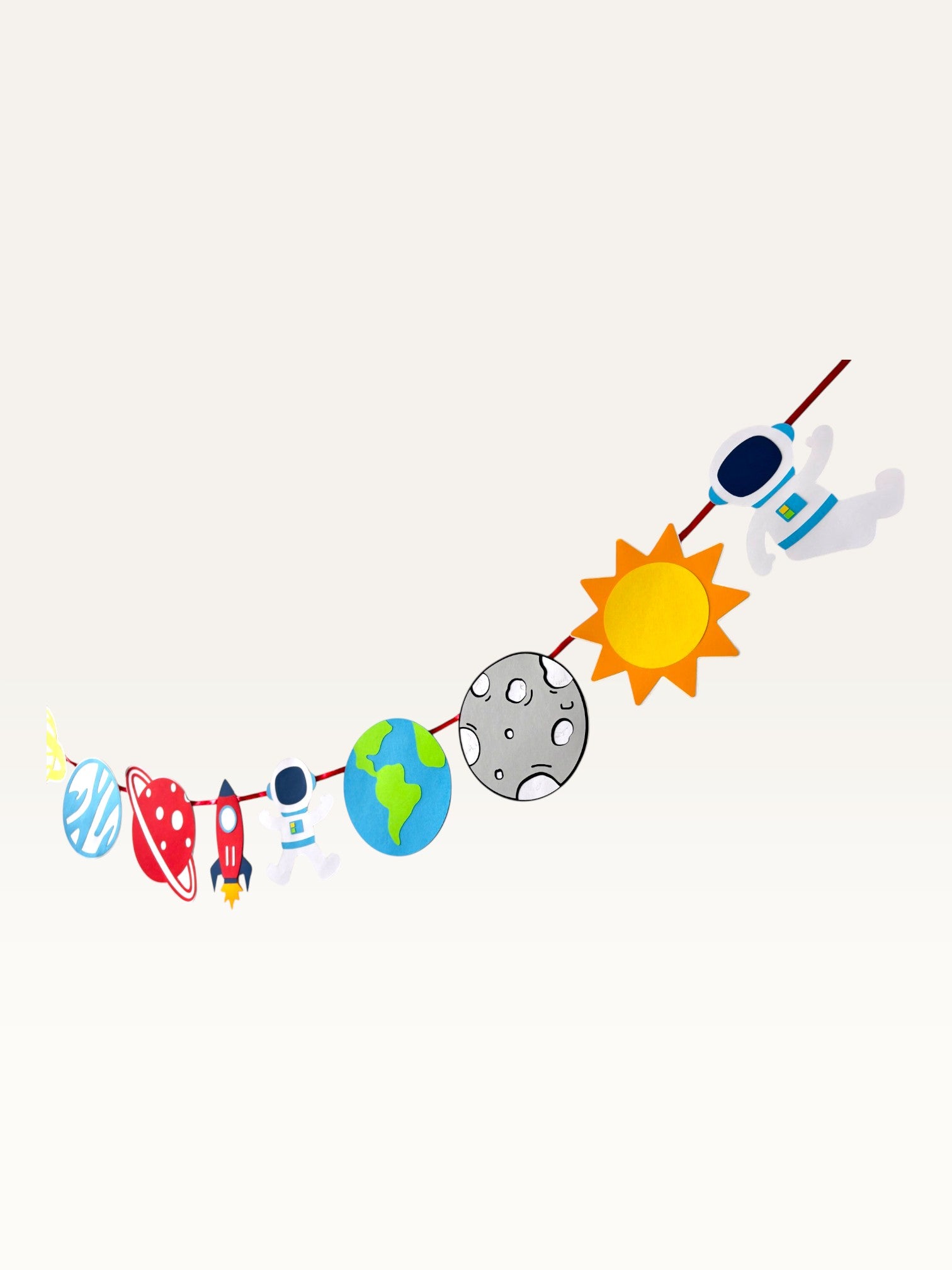 Paper Party Studio space adventure garland featuring paper cutouts of astronauts, rockets, and planets on a cord.
