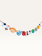 Paper Party Studio space adventure garland featuring colorful paper astronauts, rockets, and planets on a hanging cord.