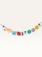 Paper Party Studio space adventure garland featuring colorful paper astronauts, rockets, and planets on a string.