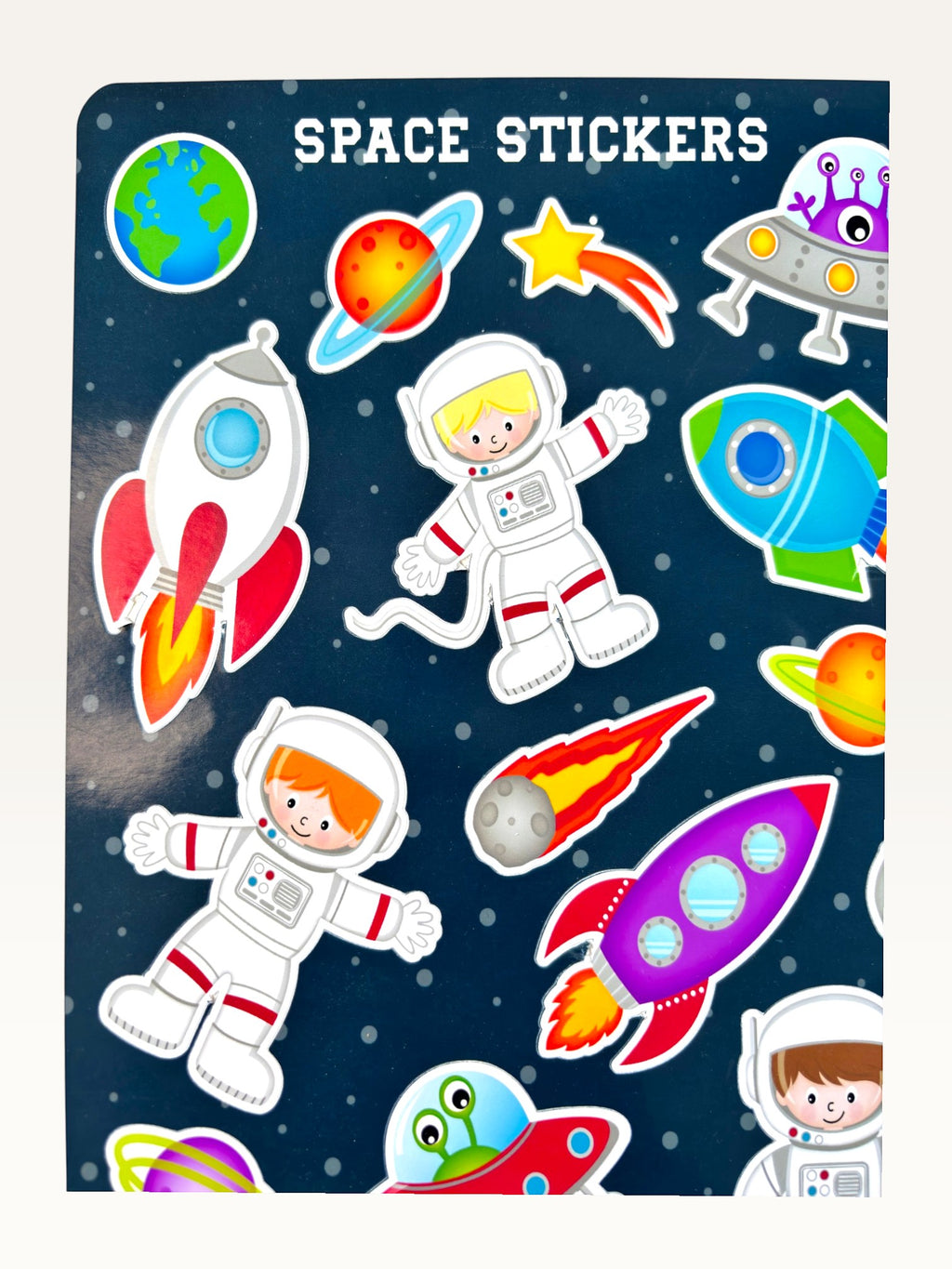 Paper Party Studio space explorer sticker sheet featuring rockets, astronauts, and planets on a deep blue background.