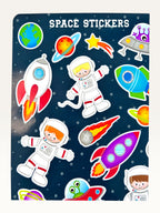 Paper Party Studio space explorer sticker sheet featuring rockets, astronauts, and planets on a deep blue background.