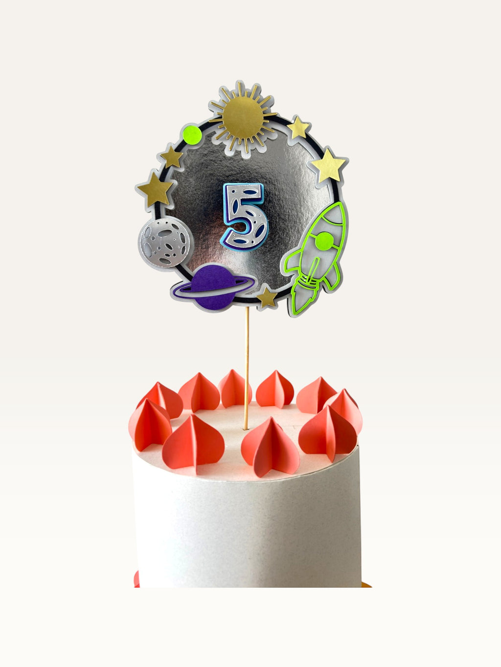 Paper Party Studio space-themed number 5 cake topper with rocket, planets, and stars on a silver foil background.