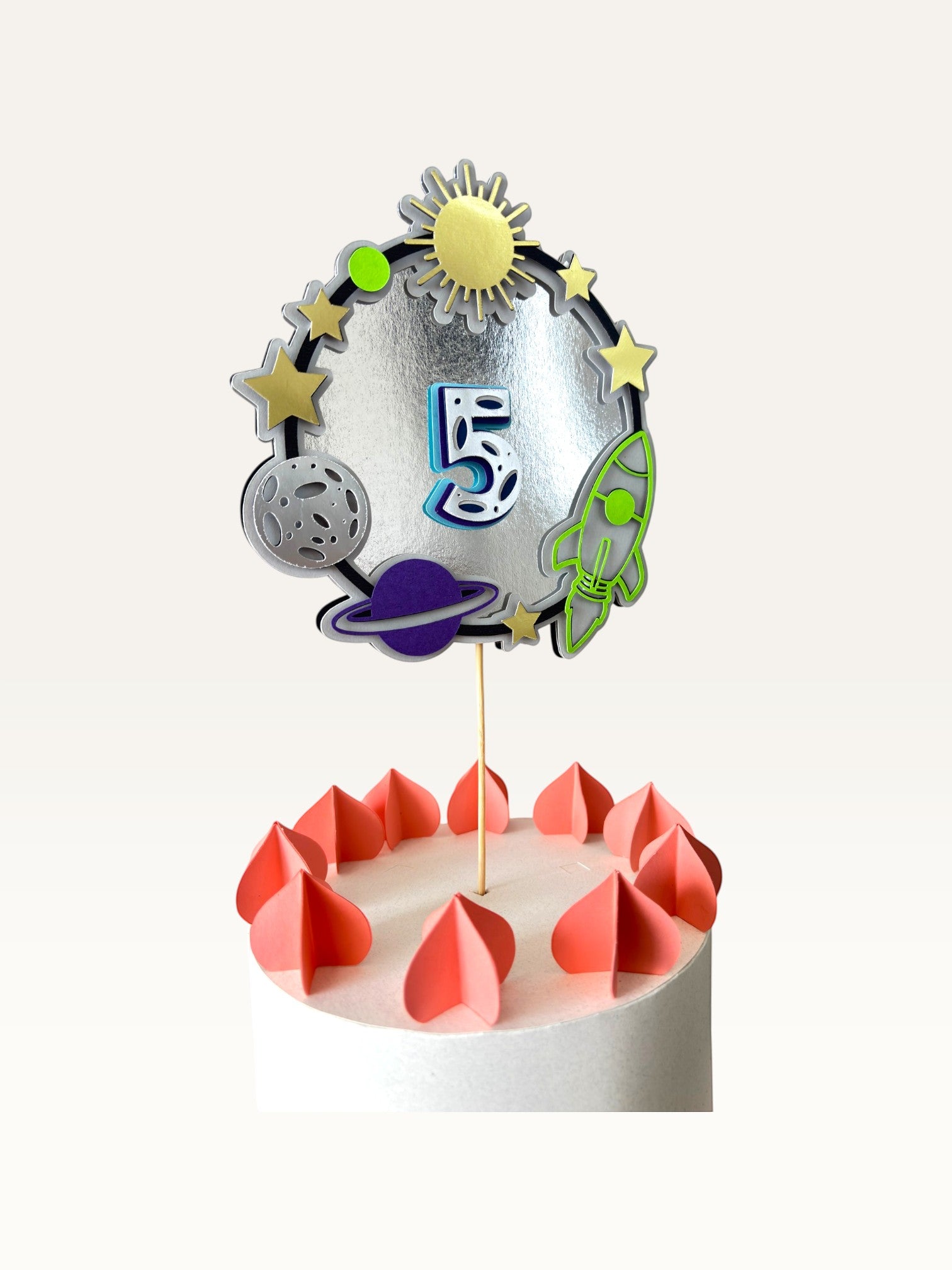 Paper Party Studio personalised space-themed number 5 cake topper with silver foil, rocket, planets, and gold stars.