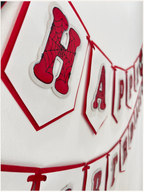 Paper Party Studio red and white swallowtail Happy Birthday banner with black spider-web detailing on each letter