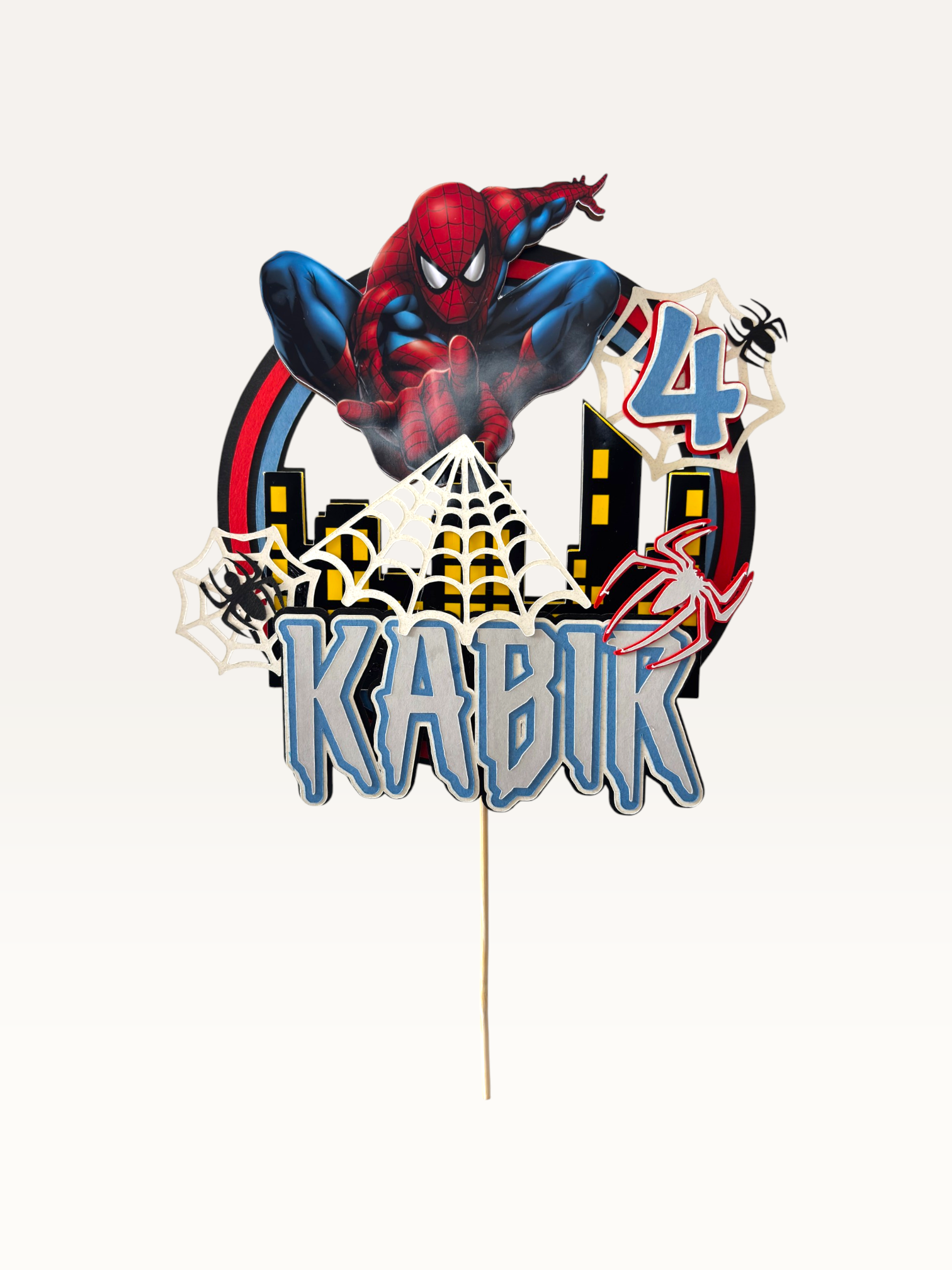 Paper Party Studio spider web hero cake topper with comic city skyline and web details