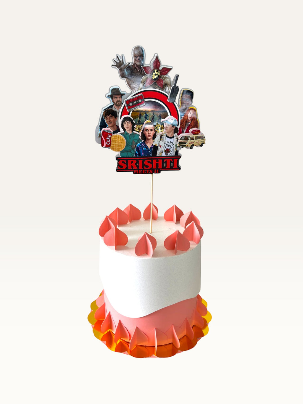 Paper Party Studio personalised Stranger Things themed cake topper featuring character cutouts on a small cake.