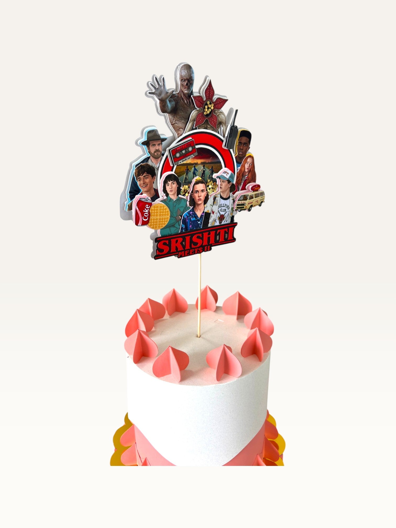 Paper Party Studio personalised Stranger Things themed cake topper featuring character cutouts and retro graphics.