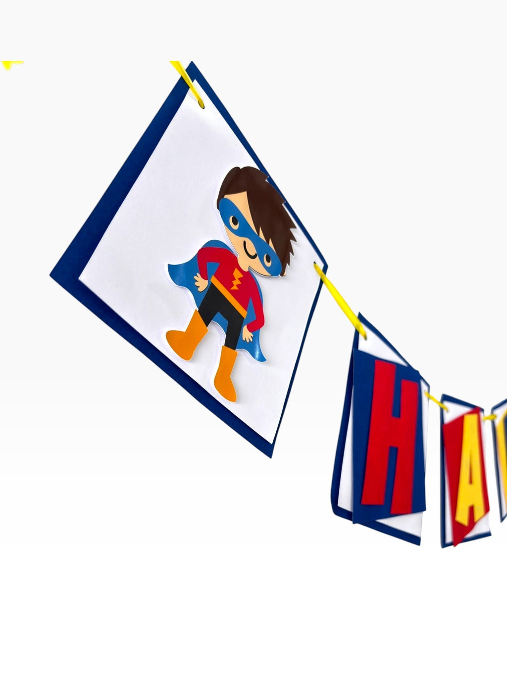 Paper Party Studio superhero birthday banner featuring a masked hero character flag and layered red and yellow letters