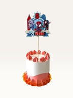 Paper Party Studio personalised superhero cake topper featuring a comic city skyline, masked heroes, and age number.