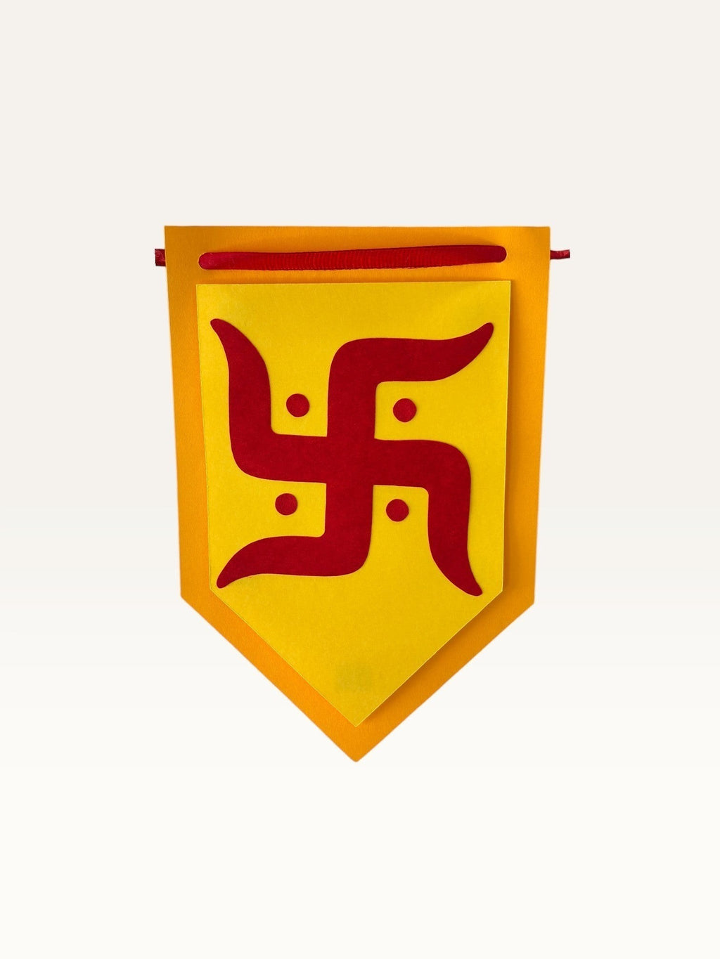 Paper Party Studio yellow and red cardstock pentagon flag featuring a sacred Swastik symbol for festive home decor.