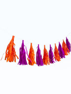 Paper Party Studio orange and purple tissue paper tassel garland for party decorations and photo backdrops.