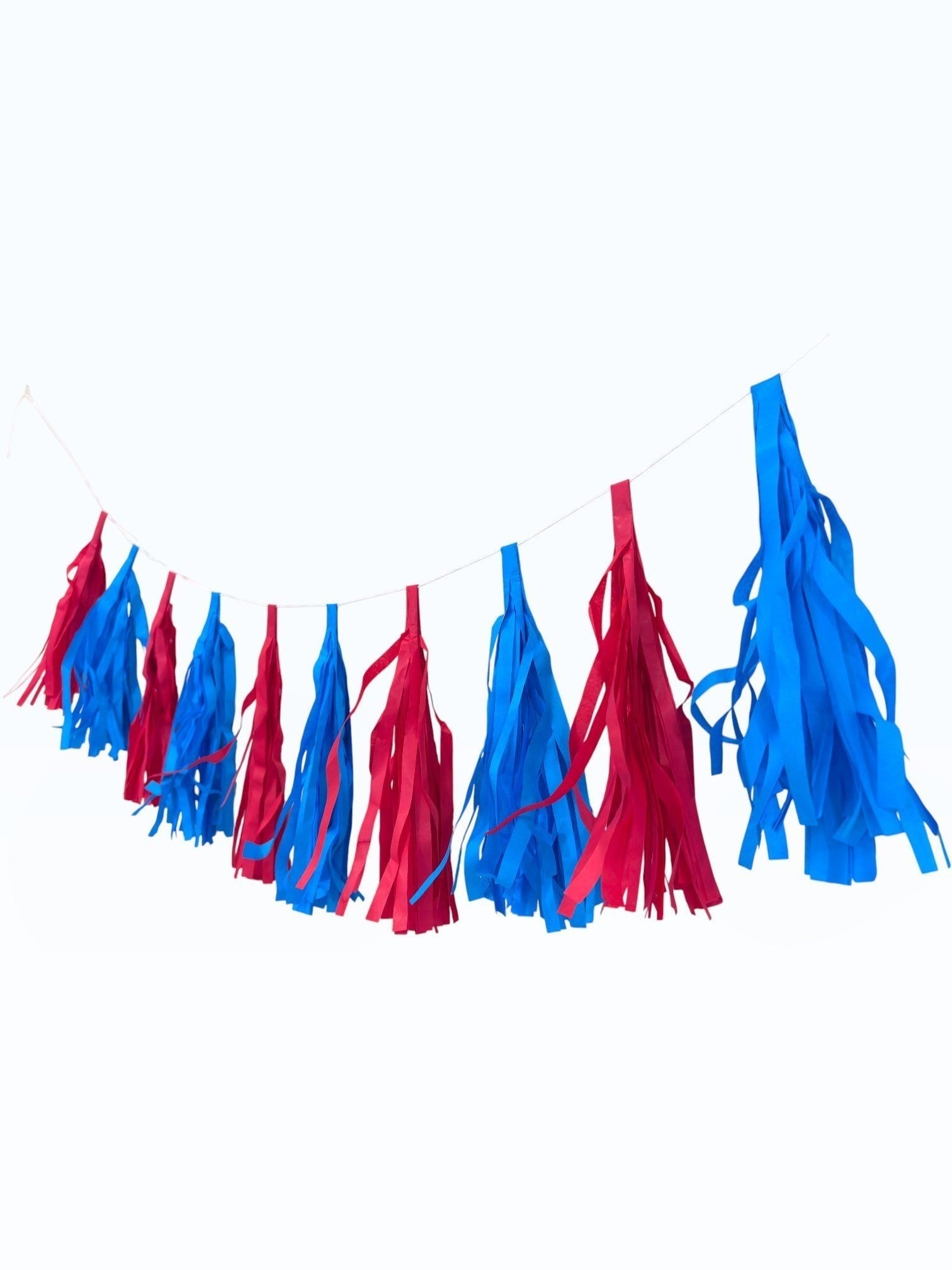 Paper Party Studio red and blue tissue paper tassel garland for party decorations and photo backdrops.