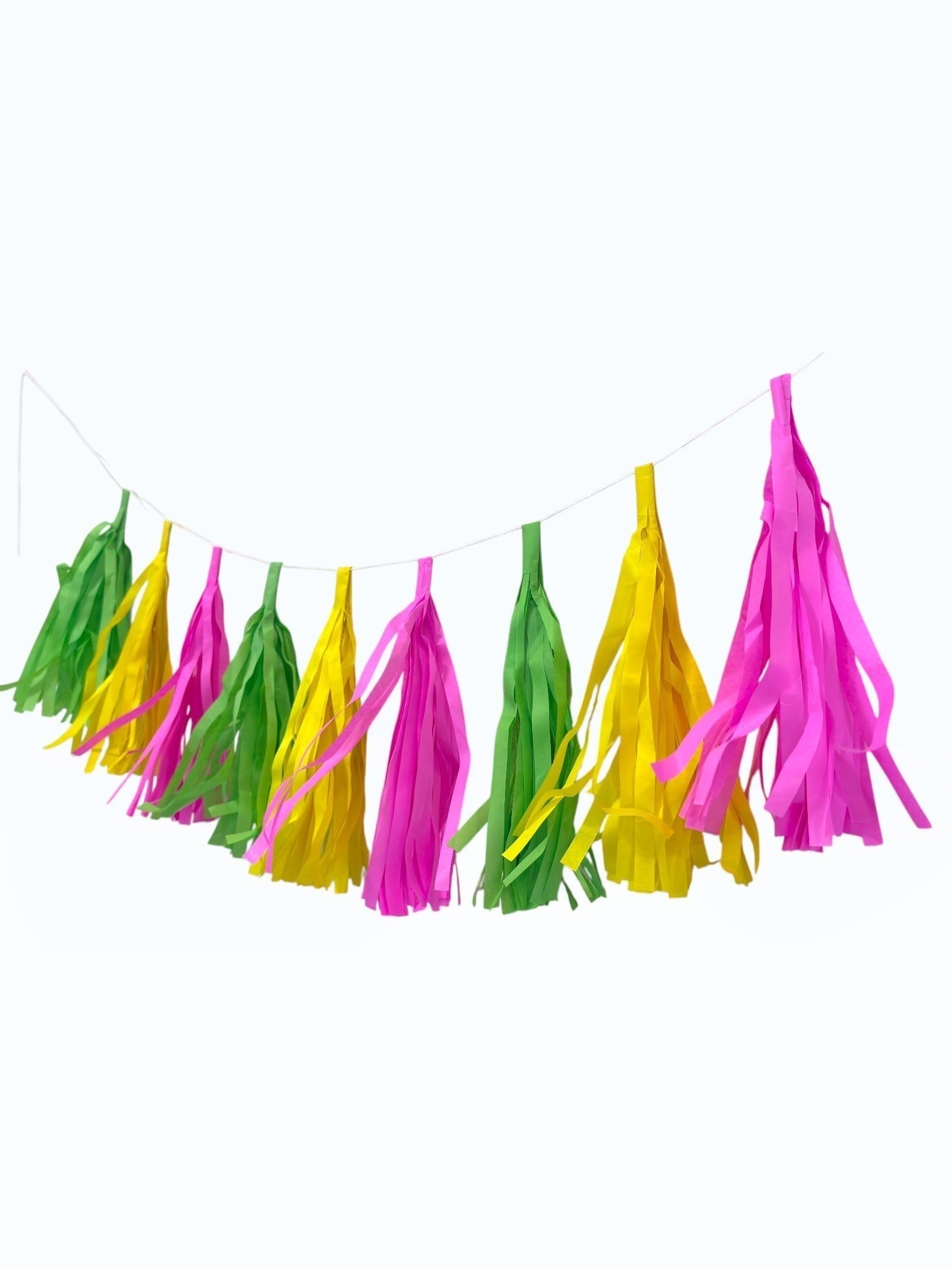 Paper Party Studio handmade tissue paper tassel garland in bright pink, yellow, and green for party decoration.
