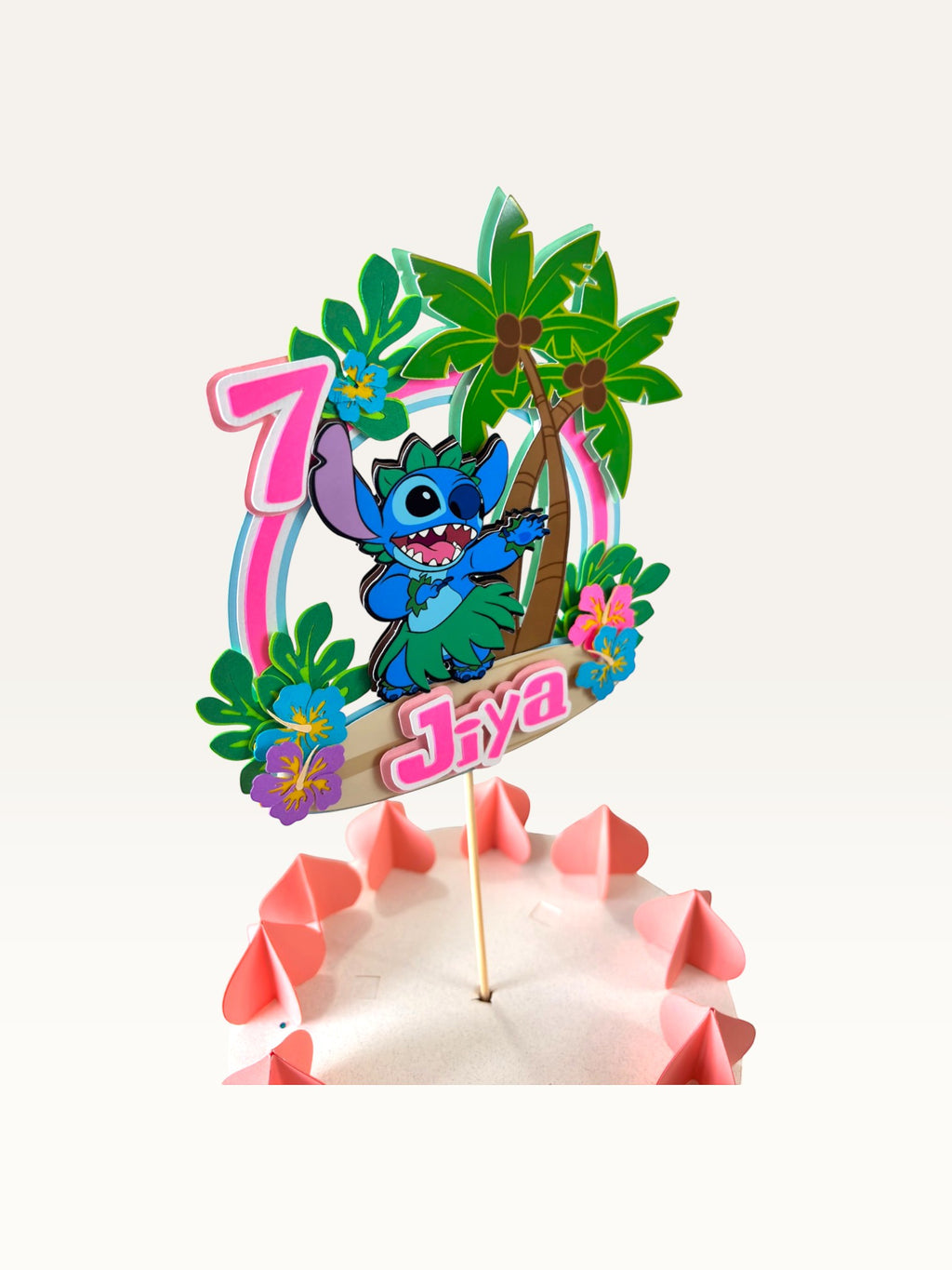 Paper Party Studio personalised tropical luau cake topper featuring a blue alien, palm trees, and hibiscus flowers.