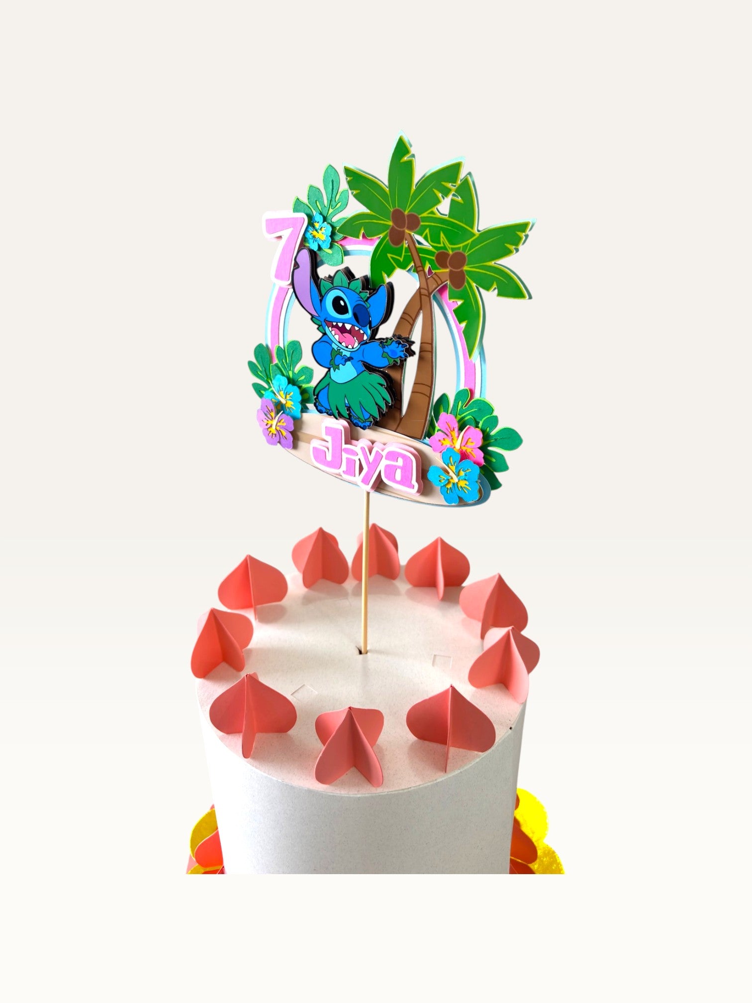 Paper Party Studio personalised tropical luau cake topper featuring a blue alien, palm trees, and hibiscus flowers.