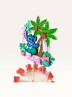 Paper Party Studio personalised tropical luau cake topper featuring a blue alien, palm trees, and hibiscus flowers.