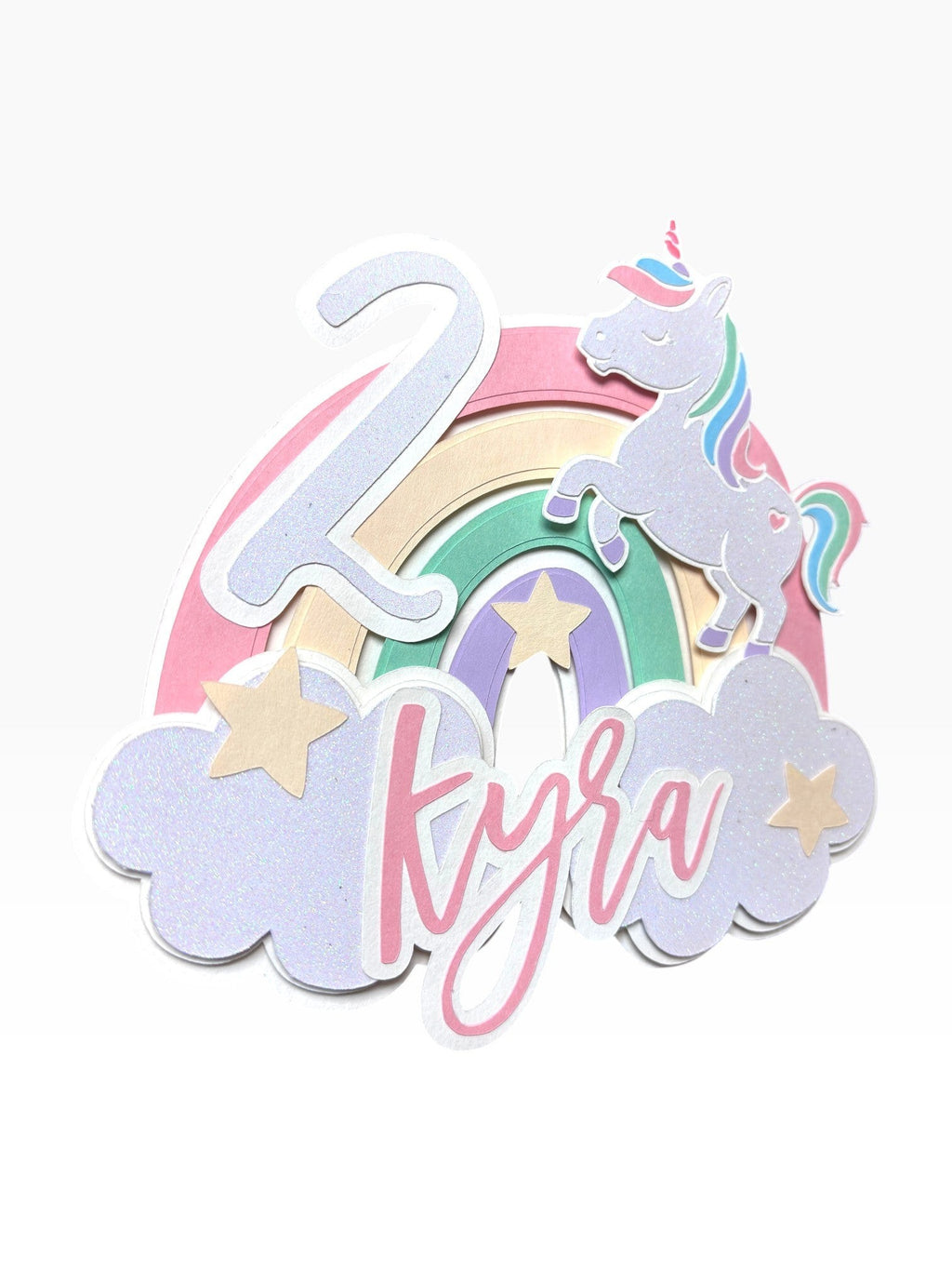 Paper Party Studio personalised unicorn cake topper with pastel rainbow, clouds, stars, custom name and age.