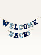 Paper Party Studio Welcome Back banner in navy and sky blue varsity letters strung on a gold cord.
