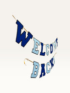 Paper Party Studio Welcome Back banner featuring navy and sky blue varsity letters on a gold cord for homecomings.
