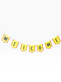 Paper Party Studio yellow paper bunting with red scalloped edges spells out WELCOME in black letters.
