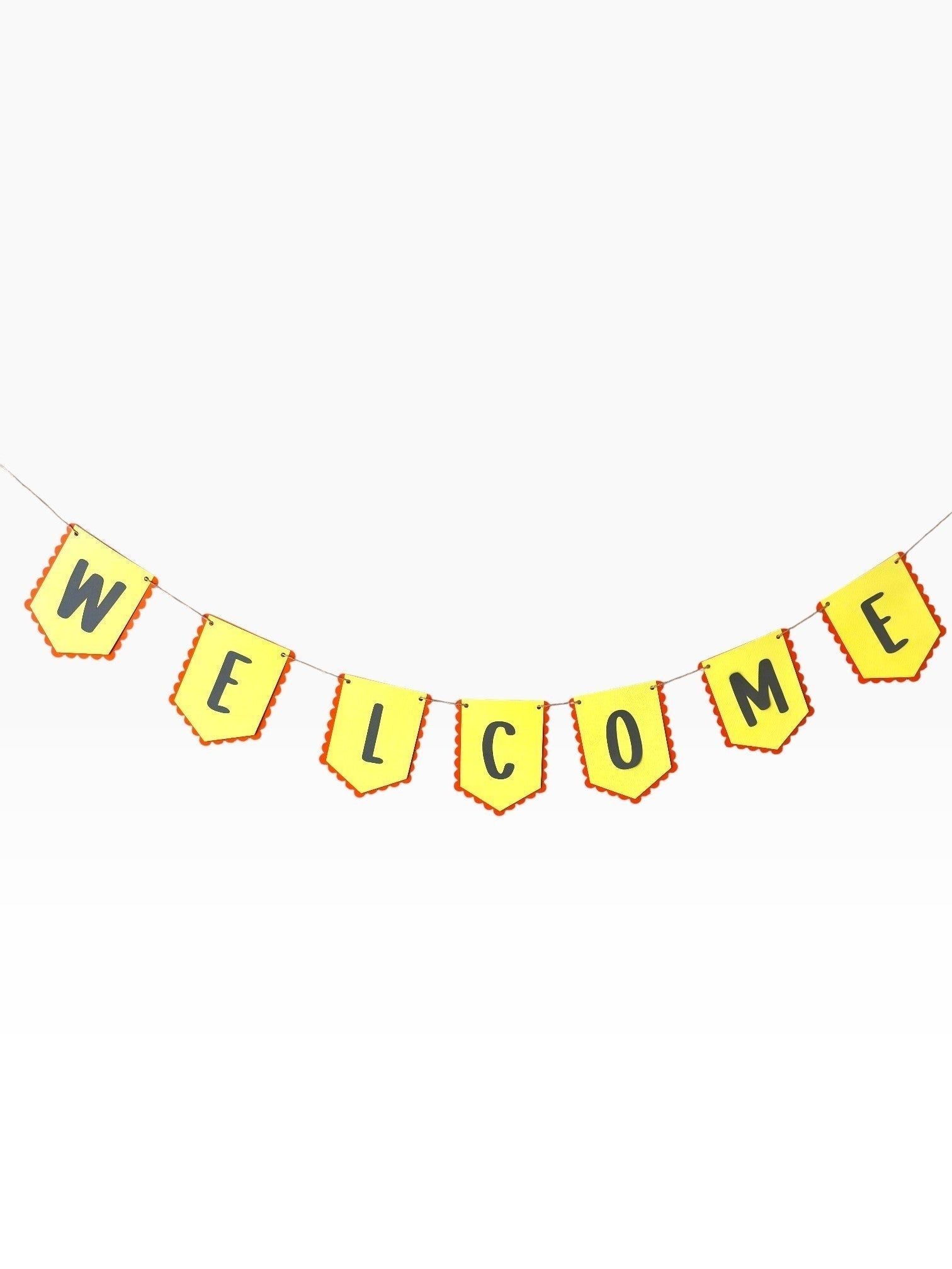 Paper Party Studio yellow paper bunting with red scalloped edges spells out WELCOME in black letters.