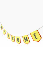 Paper Party Studio yellow paper bunting with scalloped red edges spells out WELCOME in black letters.