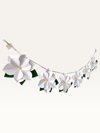 Paper Party Studio white paper flower garland with layered blossoms, yellow centers, and green leaves on a silver cord.