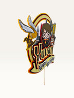 Paper Party Studio personalised wizard school cake topper with a young wizard, owl, and castle in red and gold.