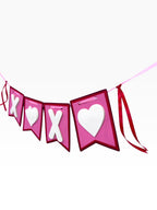 Paper Party Studio XOXO banner with pink flags, white X and heart cut-outs, and red ribbon ties.
